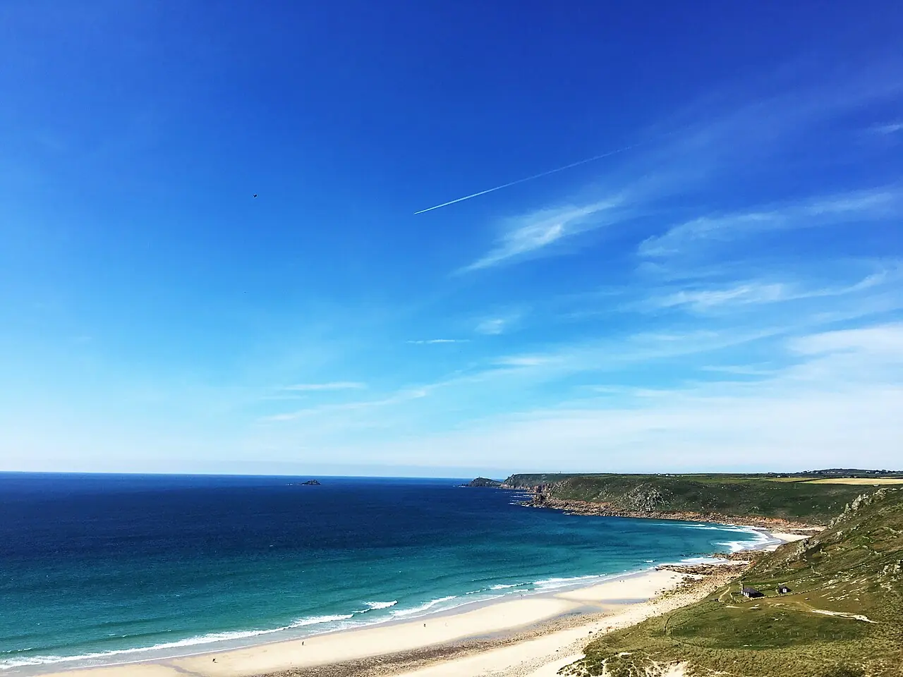 This is the beach at Sennen, also known as Whitesands Beach. The Atlantic swell provides the surf for which its noted. The view is looking down from Cove Road, showing the.