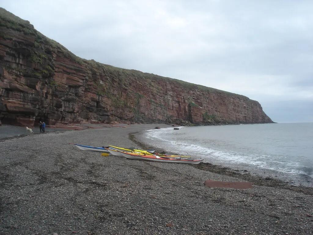 Cliffs south of Fleswick The beach of Fleswick Bay is a convenient stopping point for lunch on a sea kayak trip, avoiding the crowds of St. Bees. The cliff scenery loses height.