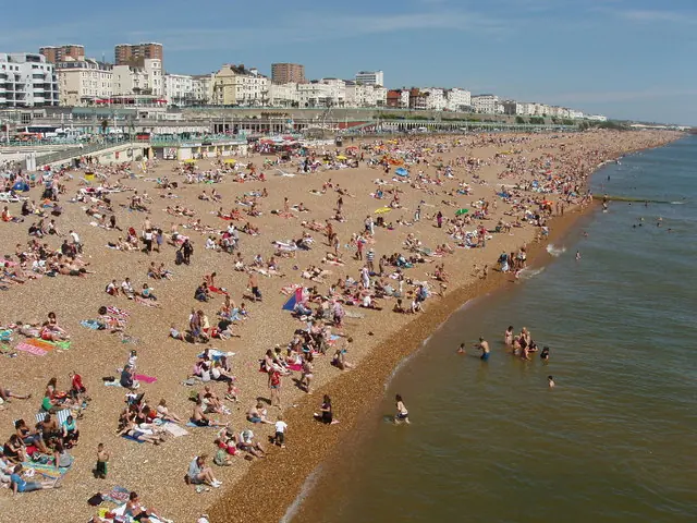 Crowded Brighton beach east of Palace Pier Even in May a hot Sunday brings a crowd of sunbathers and a few paddlers to the beach.