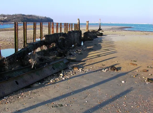 Breakwater at Bembridge Point. The eastern side to the entrance to Bembridge Harbour which is on the left. Portsmouth on the horizon with the Spinnaker Tower visible between the.