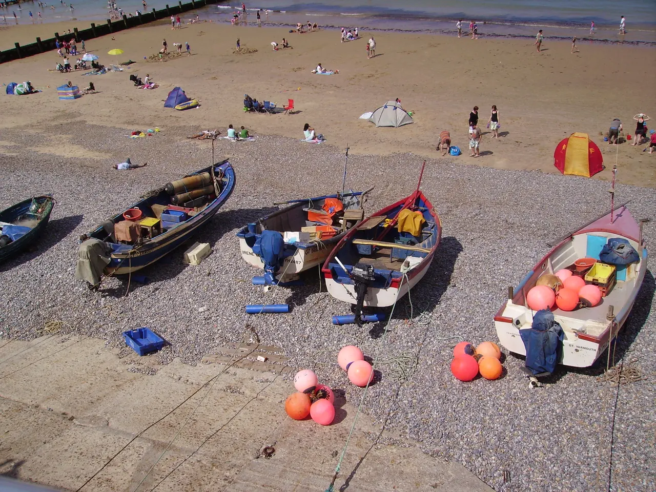 A row of fishing boats at the bottom of the fishermans slope in the town of Sheringham , Norfolk, England