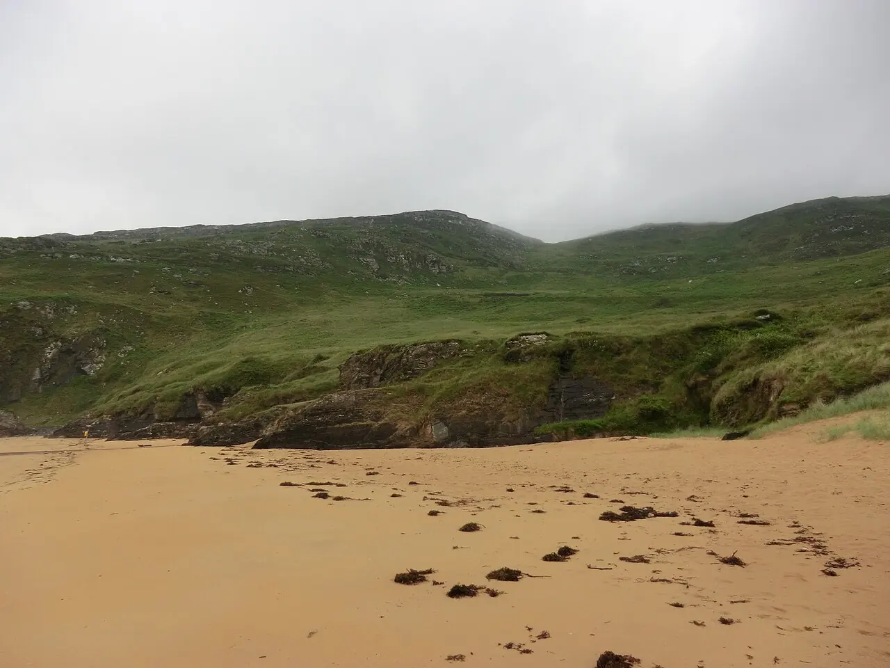 Golden sand and green hills above Stocker Strand at Portsalon.