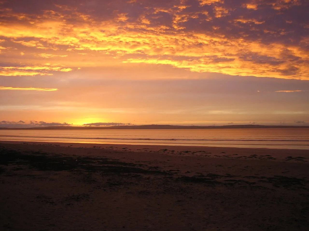 Orange sunset above the long sandy shore at Enniscrone.