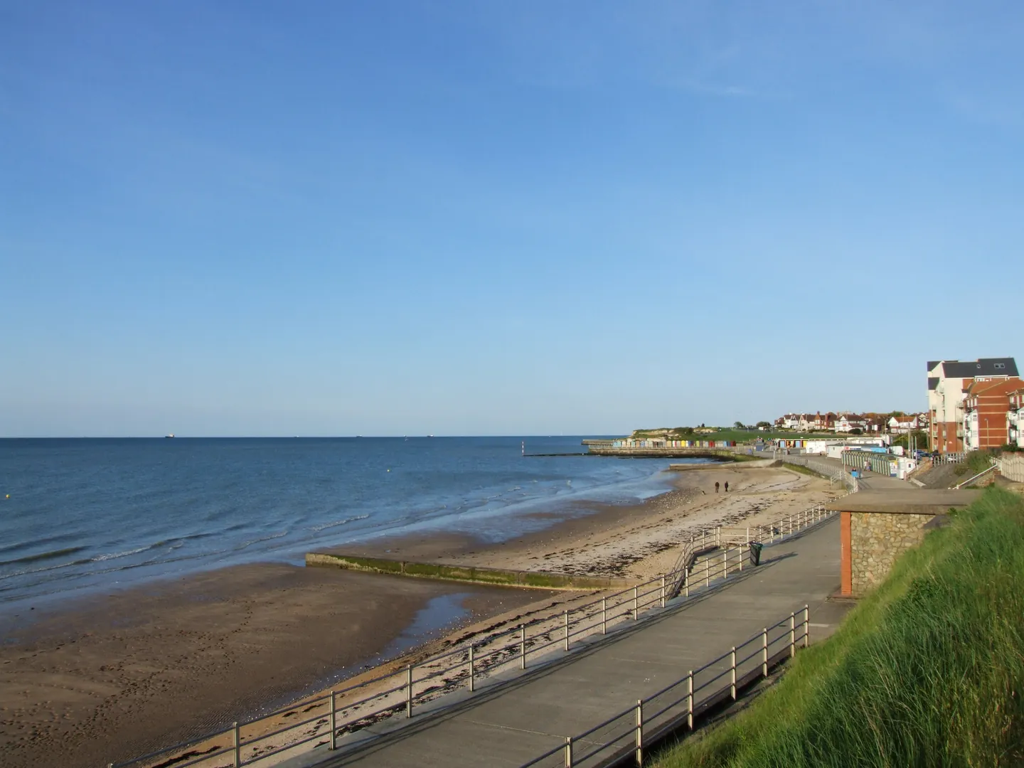 The sandy shoreline and promenade at St Mildred’s Bay